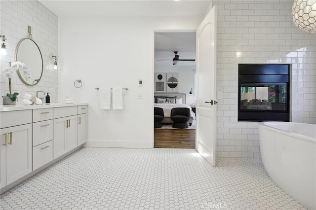 4322 Alcove Ave, Studio City, CA 91604 - ensuite bathroom featuring tile walls, vanity, a soaking tub, ceiling fan, and tile patterned floors