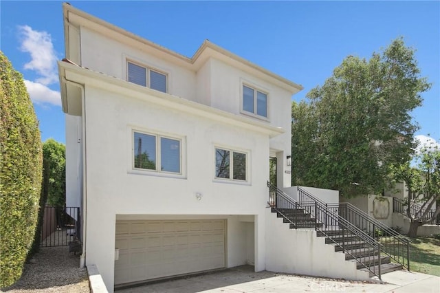 4322 Alcove Ave, Studio City, CA 91604 - view of front of home with stairs, a garage, stucco siding, and driveway