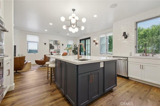 4322 Alcove Ave, Studio City, CA 91604 - kitchen featuring stainless steel dishwasher, a sink, light countertops, wood finished floors, and recessed lighting