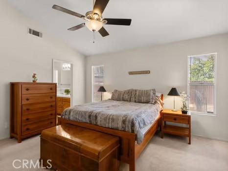 11191 Baker Ln, Riverside, CA 92505 - bedroom with light colored carpet, lofted ceiling, ceiling fan, and ensuite bathroom