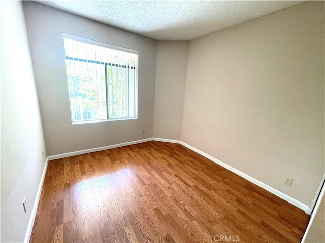 2563 Plaza Del Amo Unit 304, Torrance, CA 90503 - empty room with wood finished floors, baseboards, and a textured ceiling