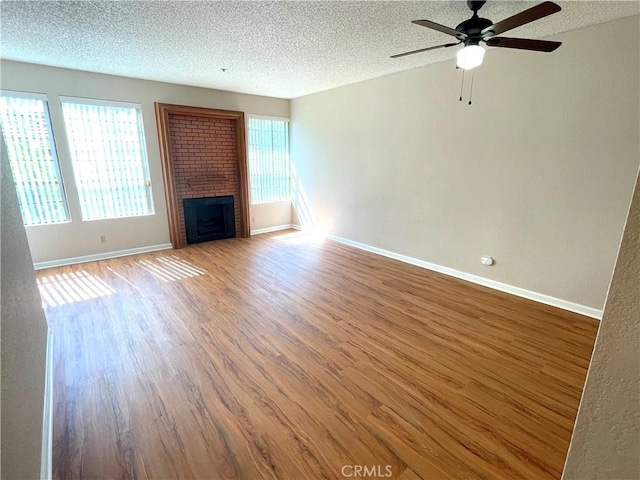 2563 Plaza Del Amo Unit 304, Torrance, CA 90503 - unfurnished living room featuring healthy amount of natural light, a textured ceiling, wood finished floors, and a ceiling fan