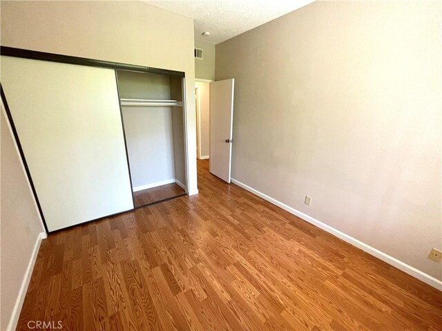 2563 Plaza Del Amo Unit 304, Torrance, CA 90503 - unfurnished bedroom featuring wood finished floors, baseboards, and a closet