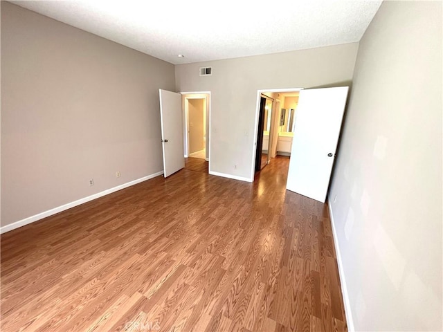2563 Plaza Del Amo Unit 304, Torrance, CA 90503 - unfurnished bedroom featuring light wood finished floors, baseboards, and a textured ceiling