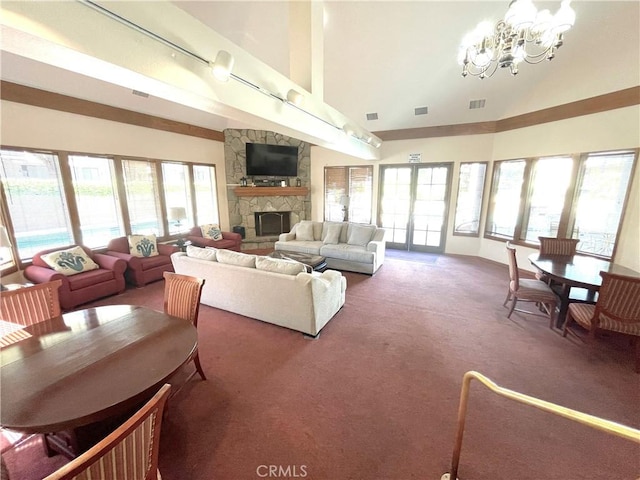 2563 Plaza Del Amo Unit 304, Torrance, CA 90503 - living area featuring high vaulted ceiling, a stone fireplace, carpet floors, and a chandelier