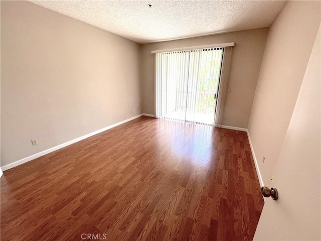 2563 Plaza Del Amo Unit 304, Torrance, CA 90503 - empty room featuring baseboards, wood finished floors, and a textured ceiling