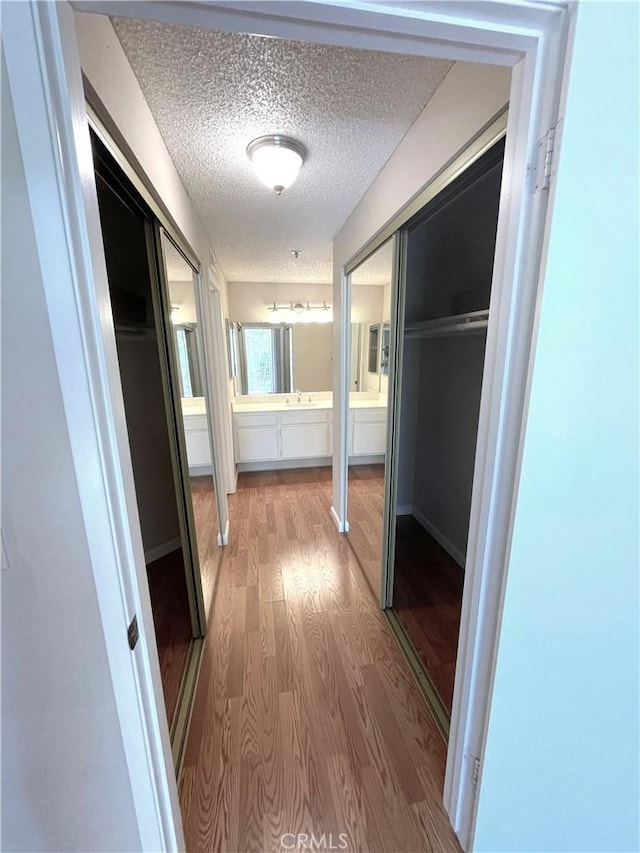 2563 Plaza Del Amo Unit 304, Torrance, CA 90503 - hallway with wood finished floors and a textured ceiling