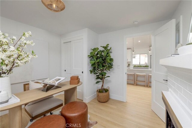 556 Through St, Laguna Beach, CA 92651 - home office featuring light wood finished floors and a fireplace