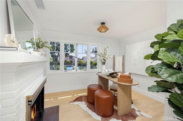 556 Through St, Laguna Beach, CA 92651 - dining room featuring a fireplace with flush hearth and wood finished floors