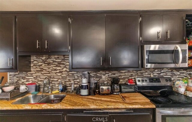 4547 W 141st St, Hawthorne, CA 90250 - kitchen with stainless steel appliances, backsplash, and dark brown cabinetry