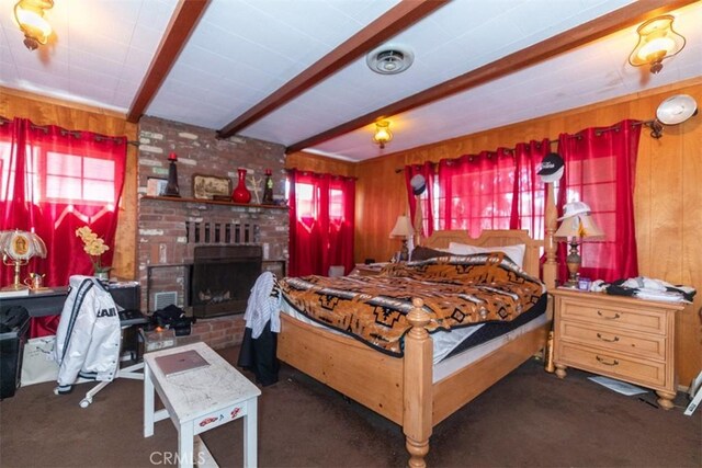 4547 W 141st St, Hawthorne, CA 90250 - bedroom with multiple windows, beam ceiling, a fireplace, wood walls, and carpet flooring
