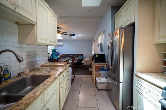 161 N Cota St, Corona, CA 92882 - kitchen featuring freestanding refrigerator, cream cabinets, a sink, tasteful backsplash, and open floor plan
