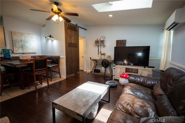 161 N Cota St, Corona, CA 92882 - living area featuring a barn door, a wall unit AC, wood finished floors, a skylight, and ceiling fan