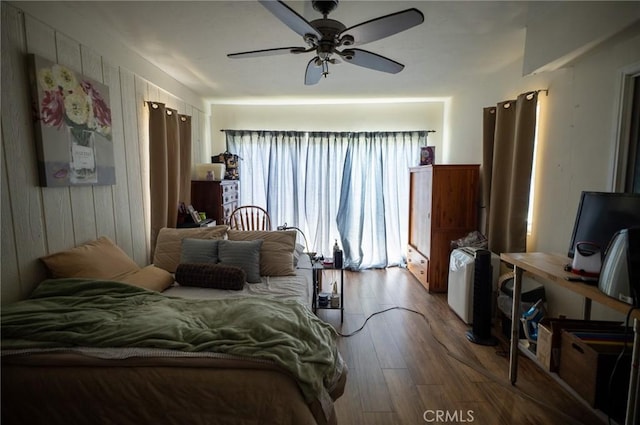 161 N Cota St, Corona, CA 92882 - bedroom with wood finished floors, wood walls, and a ceiling fan