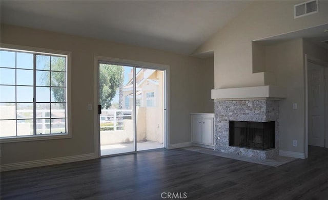 27971 Via Moreno, Laguna Niguel, CA 92677 - unfurnished living room featuring wood finished floors, vaulted ceiling, baseboards, and a stone fireplace