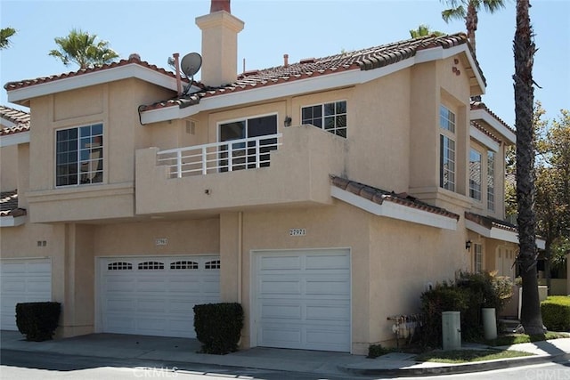 27971 Via Moreno, Laguna Niguel, CA 92677 - back of house featuring a tile roof, an attached garage, and stucco siding