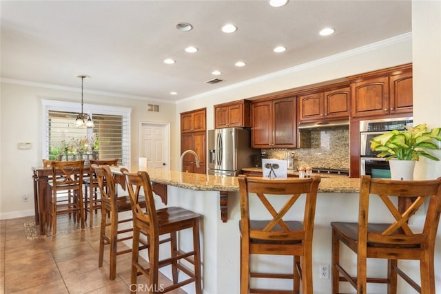 4127 Forest Highlands Cir, Corona, CA 92883 - kitchen featuring stainless steel appliances, recessed lighting, a breakfast bar, ornamental molding, and tasteful backsplash