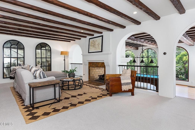 4144 Chevy Chase Dr, La Canada Flintridge, CA 91011 - carpeted living area featuring beamed ceiling, a fireplace with flush hearth, arched walkways, and recessed lighting
