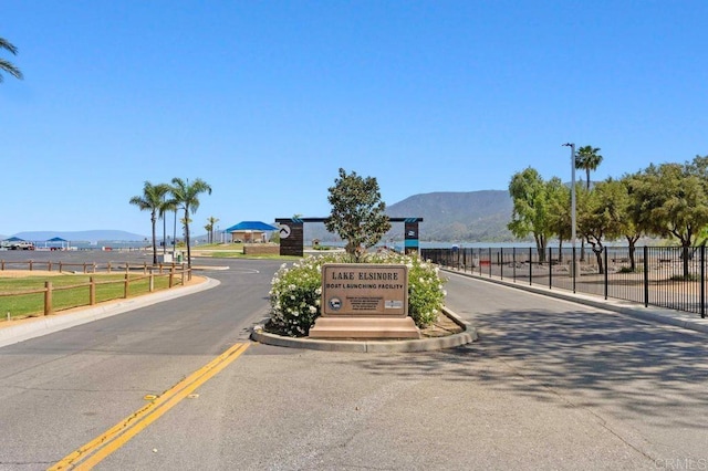 17030 Grand Ave, Lake Elsinore, CA 92530 - view of asphalt road with a mountain view, street lighting, and curbs