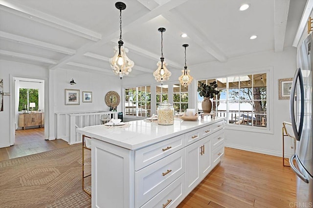 17030 Grand Ave, Lake Elsinore, CA 92530 - kitchen with light wood-type flooring, white cabinetry, a breakfast bar, recessed lighting, and hanging light fixtures