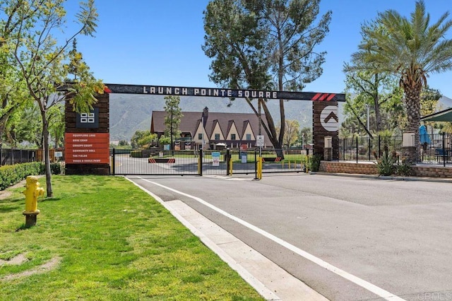 17030 Grand Ave, Lake Elsinore, CA 92530 - view of asphalt road featuring a gated entry, a gate, and curbs