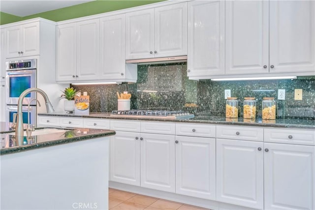 48 Via Porto Grande, Rancho Palos Verdes, CA 90275 - kitchen featuring a sink, appliances with stainless steel finishes, white cabinets, dark stone countertops, and light tile patterned floors
