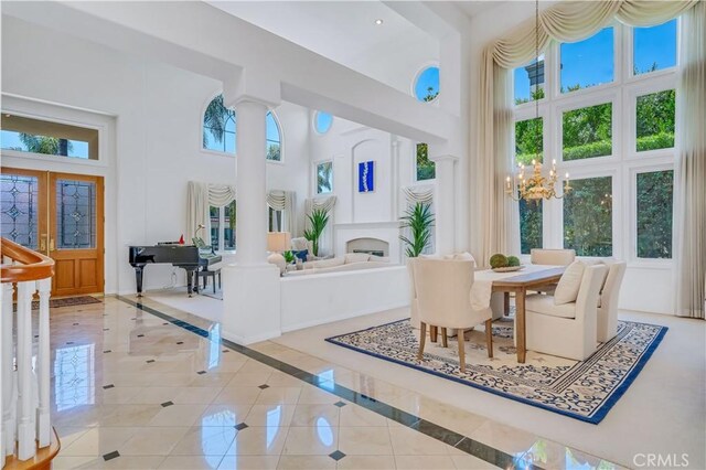 48 Via Porto Grande, Rancho Palos Verdes, CA 90275 - dining space with a high ceiling, decorative columns, french doors, tile patterned flooring, and a chandelier