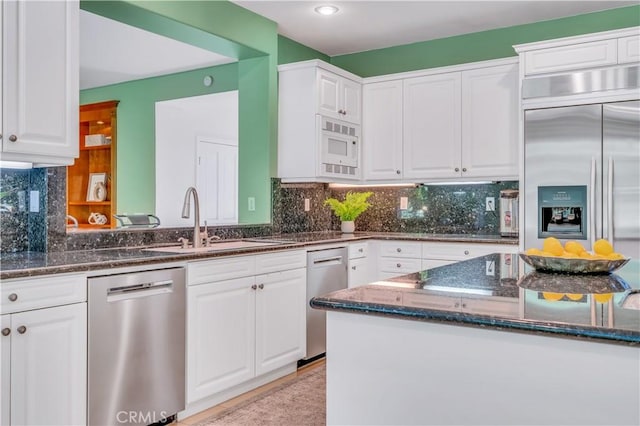 48 Via Porto Grande, Rancho Palos Verdes, CA 90275 - kitchen featuring built in appliances, a sink, white cabinets, dark stone countertops, and tasteful backsplash