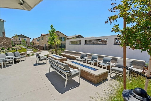 16233 Lozano St Unit 2, Fontana, CA 92336 - view of patio / terrace with a residential view and an outdoor living space with a fire pit