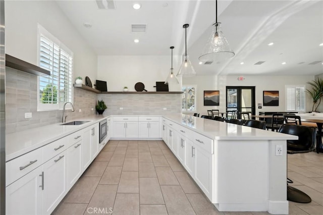 16233 Lozano St Unit 2, Fontana, CA 92336 - kitchen featuring open shelves, a sink, plenty of natural light, light countertops, and recessed lighting