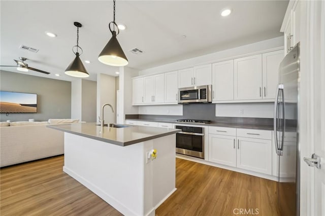 16233 Lozano St Unit 2, Fontana, CA 92336 - kitchen with appliances with stainless steel finishes, a sink, open floor plan, white cabinets, and recessed lighting