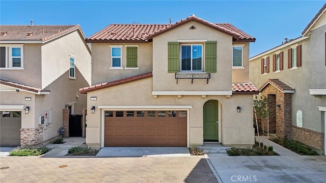 16233 Lozano St Unit 2, Fontana, CA 92336 - view of front of house with a tile roof, an attached garage, stucco siding, and driveway