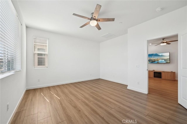 16233 Lozano St Unit 2, Fontana, CA 92336 - spare room with a ceiling fan, wood finished floors, a smoke detector, and baseboards