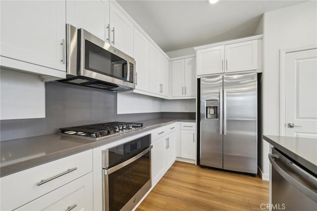 16233 Lozano St Unit 2, Fontana, CA 92336 - kitchen featuring appliances with stainless steel finishes, white cabinetry, and light wood-style flooring