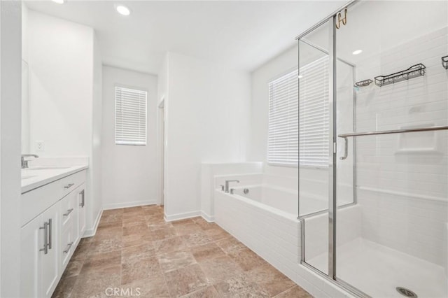 16233 Lozano St Unit 2, Fontana, CA 92336 - full bath featuring a garden tub, a shower stall, baseboards, vanity, and stone finish floors