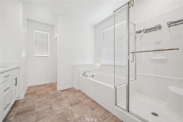 16233 Lozano St Unit 2, Fontana, CA 92336 - full bath with a garden tub, vanity, a stall shower, baseboards, and stone finish floors