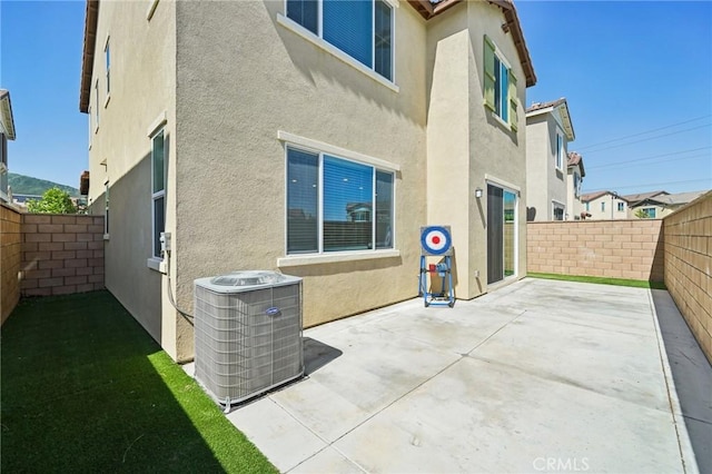 16233 Lozano St Unit 2, Fontana, CA 92336 - view of side of property featuring central air condition unit, stucco siding, a patio area, and a fenced backyard