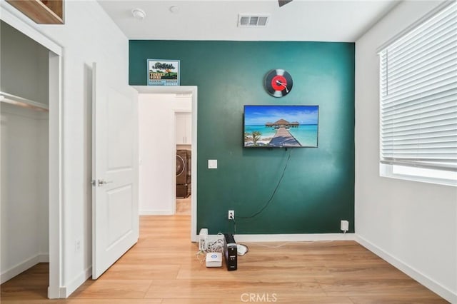 16233 Lozano St Unit 2, Fontana, CA 92336 - unfurnished bedroom with wood finished floors, baseboards, and multiple windows
