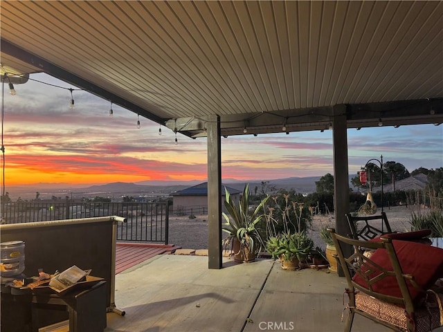 27568 Linda Vista Rd, Barstow, CA 92311 - patio terrace at dusk featuring a patio and a mountain view