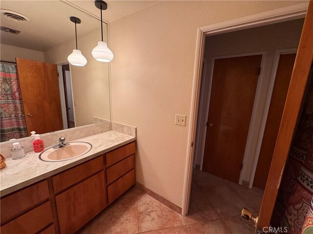 27568 Linda Vista Rd, Barstow, CA 92311 - full bathroom with vanity, tile patterned floors, and baseboards