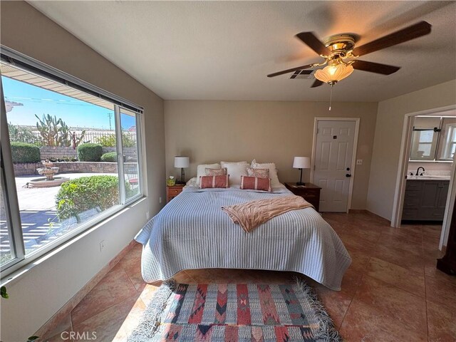 27568 Linda Vista Rd, Barstow, CA 92311 - tiled bedroom featuring a sink, baseboards, and a ceiling fan
