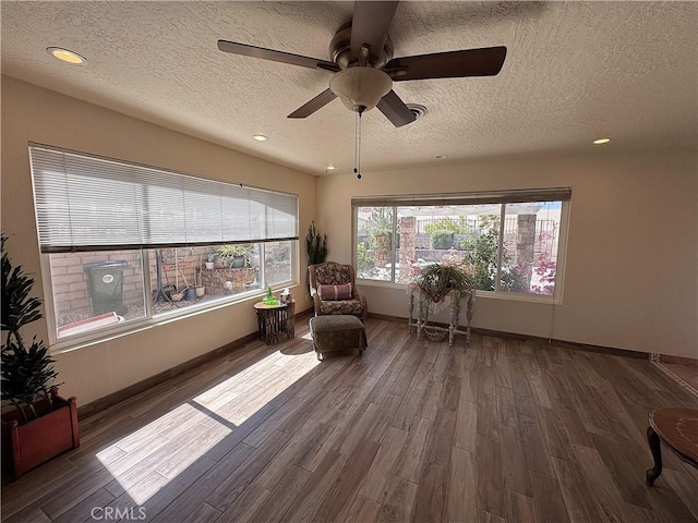 27568 Linda Vista Rd, Barstow, CA 92311 - sitting room featuring a textured ceiling, wood finished floors, a ceiling fan, baseboards, and recessed lighting