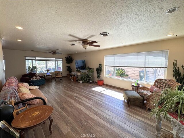 27568 Linda Vista Rd, Barstow, CA 92311 - living area with ceiling fan, wood finished floors, a textured ceiling, and recessed lighting