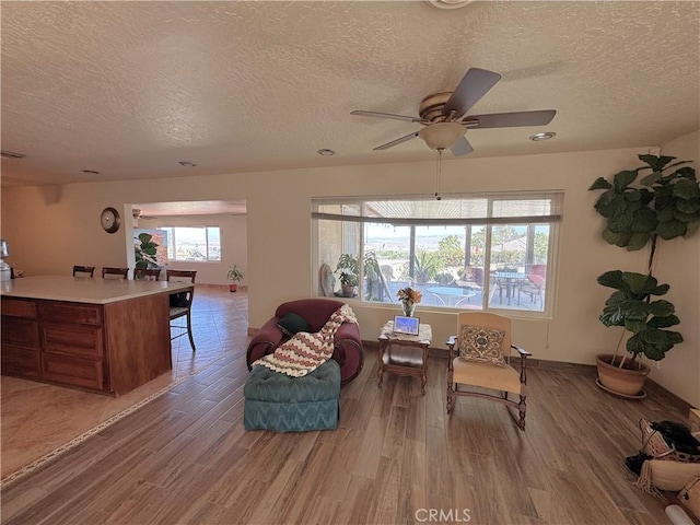 27568 Linda Vista Rd, Barstow, CA 92311 - living room with a textured ceiling, wood finished floors, and ceiling fan