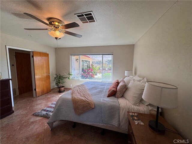 27568 Linda Vista Rd, Barstow, CA 92311 - bedroom featuring a textured ceiling and a ceiling fan