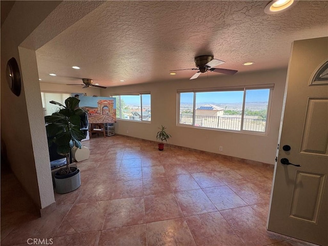 27568 Linda Vista Rd, Barstow, CA 92311 - spare room featuring a ceiling fan, a textured ceiling, recessed lighting, and tile patterned flooring
