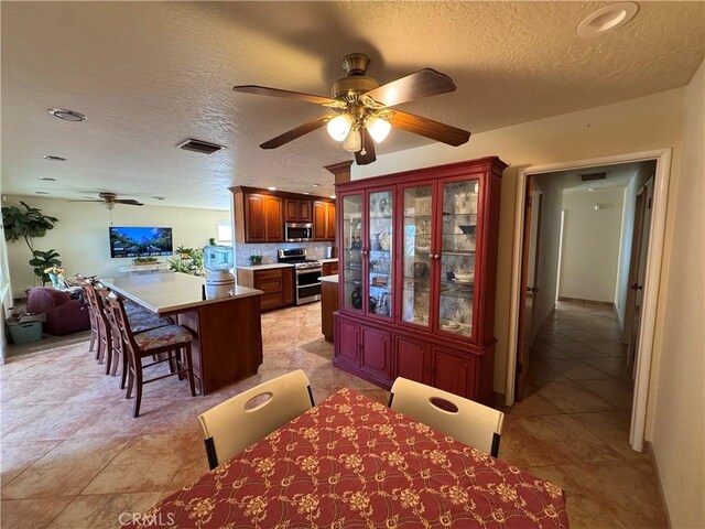 27568 Linda Vista Rd, Barstow, CA 92311 - dining area with ceiling fan, a textured ceiling, light tile patterned floors, and recessed lighting