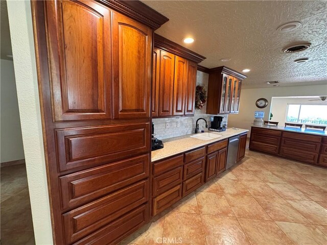 27568 Linda Vista Rd, Barstow, CA 92311 - kitchen featuring dishwasher, tasteful backsplash, a sink, a textured ceiling, and glass insert cabinets