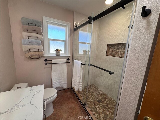 27568 Linda Vista Rd, Barstow, CA 92311 - full bathroom featuring tile patterned flooring, toilet, and a shower stall