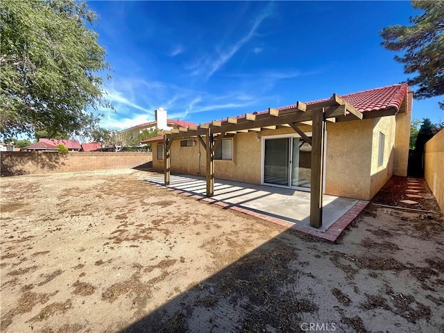 1305 Herzel Ave, Lancaster, CA 93535 - back of property featuring stucco siding, a fenced backyard, a patio area, and a tile roof